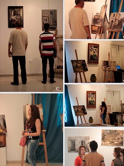 Visitors viewing the photographs on easels and walls