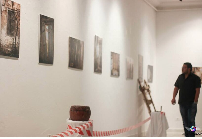 Framed photographs and artifacts on the gallery wall