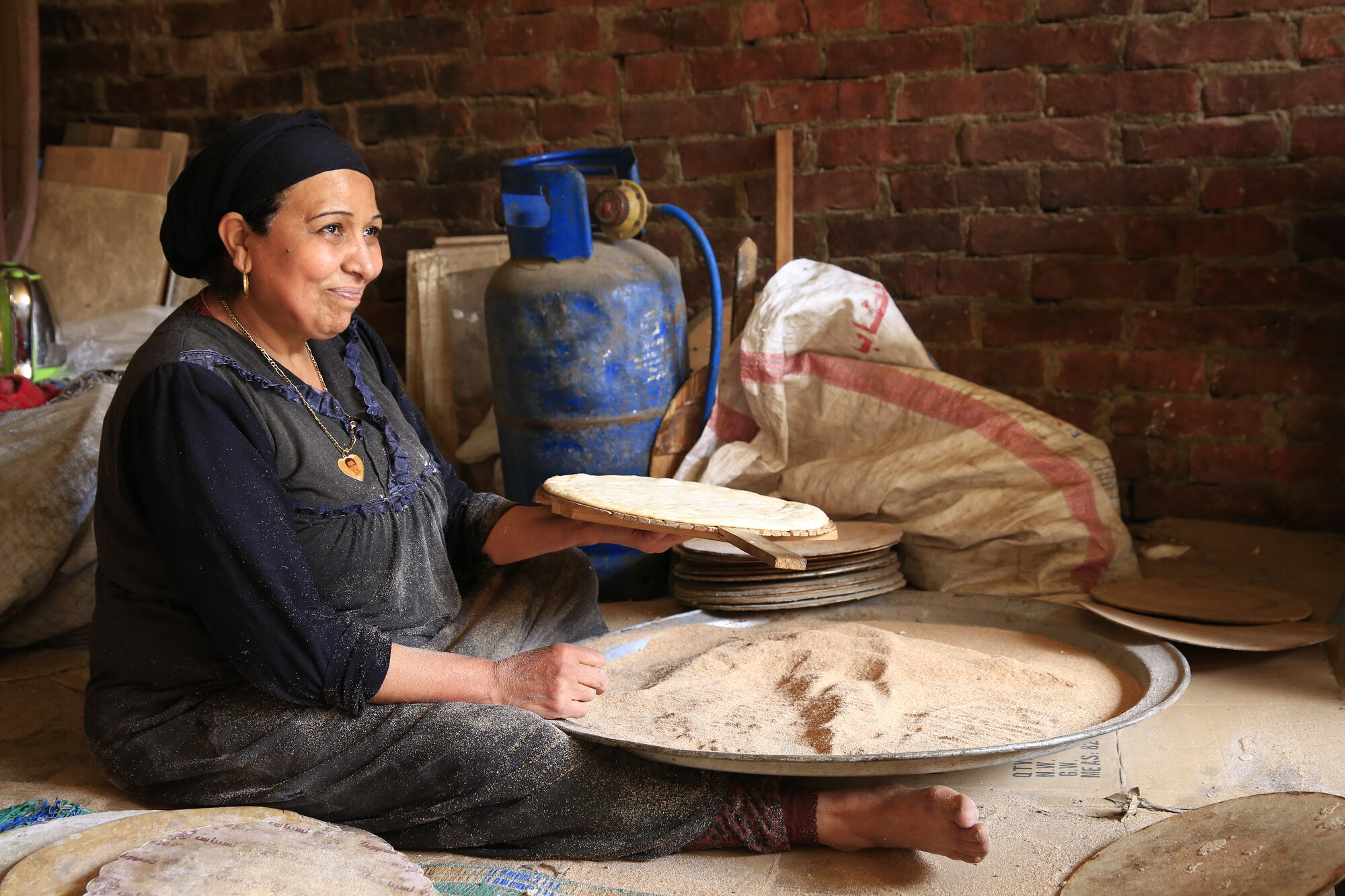 A woman preparing traditional flatbread in Cairo