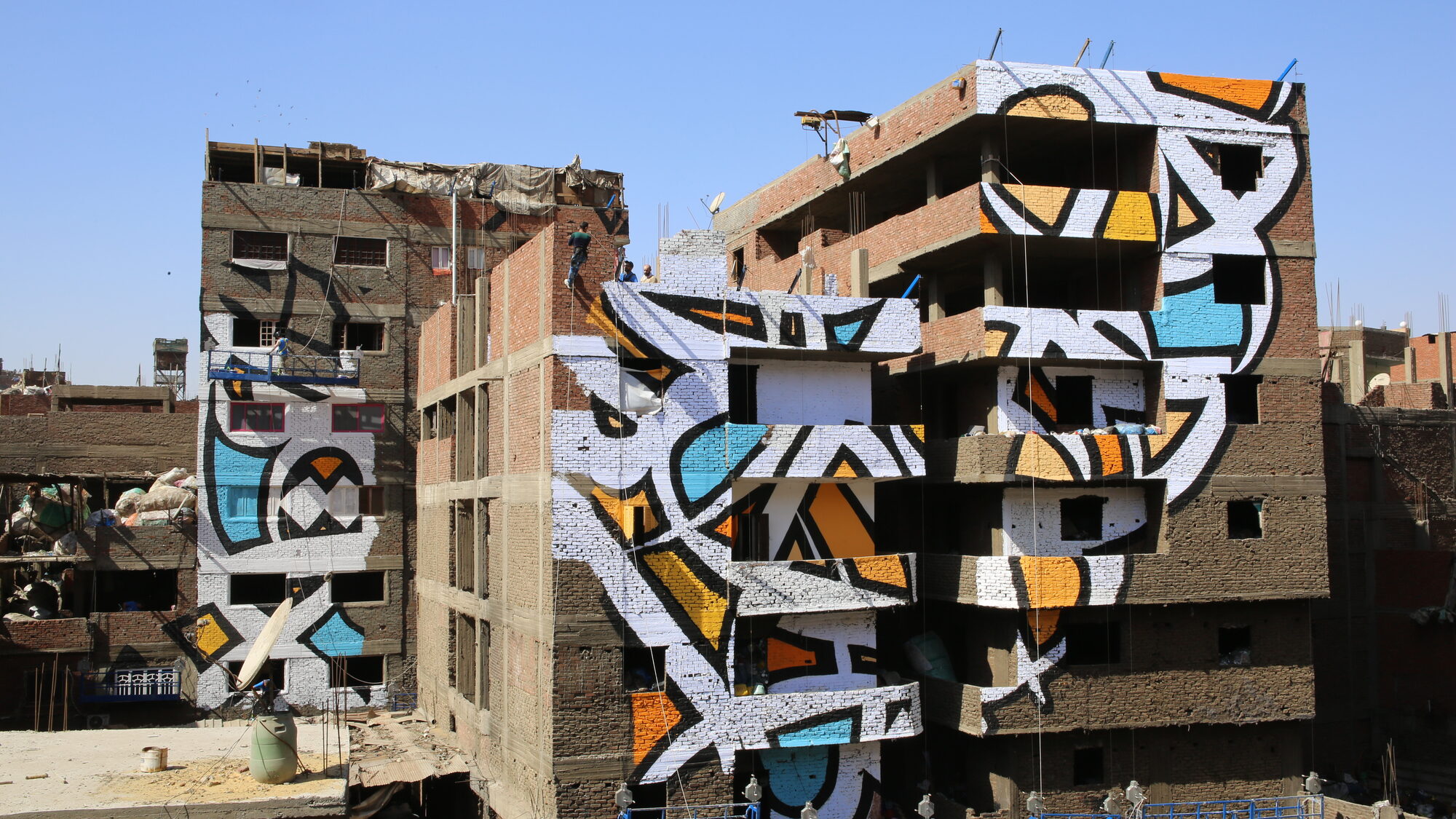 Wide view of the mural across the rooftops