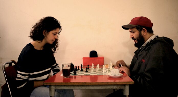 Two people playing chess in a Tunisian caf&eacute;, a still from Meanwhile in Tunisia