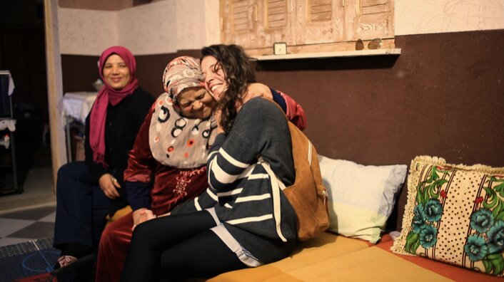 A warm reunion between In&egrave;s Khannoussi and family, a still from Meanwhile in Tunisia